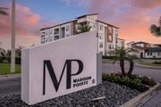 Daytona Beach apartment for rent - A large white sign with the letters MP on it in front of a building.