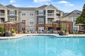 Chapel Hill townhouse for rent - Three-Bedroom Luxury Apartments in Chapel Hill, NC - The Reserve at Meadowmont - Swimming Pool With Lounge Seating, Shaded Cabanas, Large Planters, and Umbrellas.