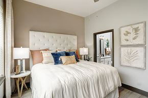 Franklin apartment for rent - A bedroom with a large bed and a mirror on the wall.