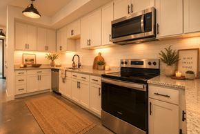 Warrenville apartment for rent - A modern kitchen with white cabinets and stainless steel appliances.