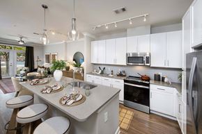 Decatur apartment for rent - A modern kitchen with a dining table set for two.