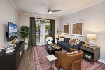Decatur apartment for rent - A living room with a brown leather chair and a black couch.