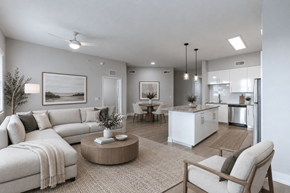 Sunrise apartment for rent - A living room with a couch, a coffee table, and a dining area in the background.