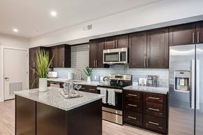 Altamonte Springs apartment for rent - A modern kitchen with dark wood cabinets and stainless steel appliances.