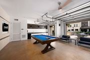 Altamonte Springs apartment for rent - A pool table is in the middle of a room with a ceiling fan and a door to the left.