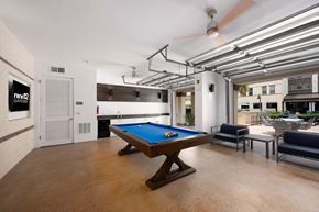 Altamonte Springs apartment for rent - A pool table is in the middle of a room with a ceiling fan and a door to the left.