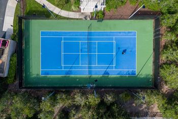 Lighted tennis/pickleball court with shaded seating