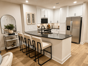 Atlanta apartment for rent - A kitchen with white cabinets and a black countertop.