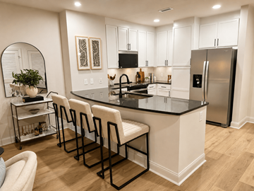 Atlanta apartment for rent - A kitchen with white cabinets and a black countertop.