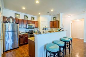 Prosper apartment for rent - a kitchen with a breakfast bar and stainless steel appliances  at Orion Prosper, Prosper