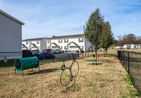 Fort Oglethorpe townhouse for rent - a park with a grassy area and houses in the background