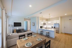 Cumming apartment for rent - A modern dining room with a wooden table set for four.