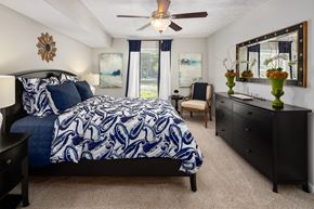 Sandy Springs apartment for rent - A bedroom with a large bed and a ceiling fan.