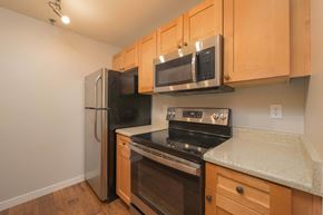 Redmond apartment for rent - A kitchen with wooden cabinets and stainless steel appliances.