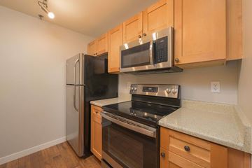 Redmond apartment for rent - A kitchen with wooden cabinets and stainless steel appliances.