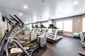 Redmond apartment for rent - A gym with treadmills, elliptical machines, and a ball.