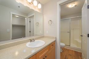 Redmond apartment for rent - A bathroom with a sink, mirror, toilet and shower.