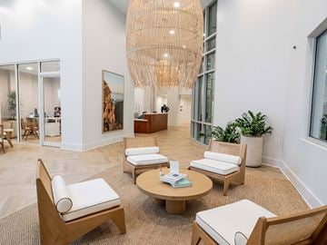 Atlanta apartment for rent - A living room with a large wooden chair and a round wooden table.