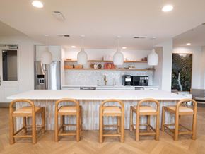 Atlanta apartment for rent - A kitchen with a white counter and wooden bar stools.