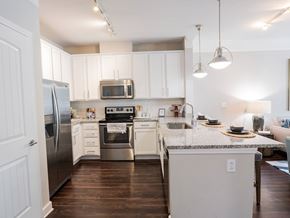 Atlanta apartment for rent - A kitchen with white cabinets and a granite countertop.