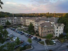 Atlanta apartment for rent - A parking lot is in front of apartment buildings.