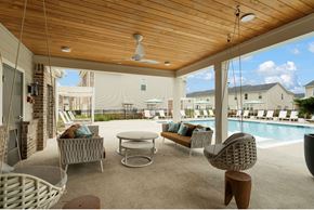 Mcdonough apartment for rent - A patio with a pool and a ceiling fan.