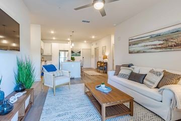 Beaufort apartment for rent - A living room with a white couch, a wooden coffee table, and a painting on the wall.