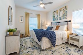 Beaufort apartment for rent - A bedroom with a bed, nightstand, and a ceiling fan.
