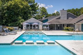 Norcross apartment for rent - A swimming pool with a house and a gazebo in the background.