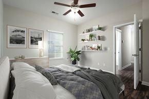 Chattanooga apartment for rent - a bedroom with a large bed and a ceiling fan