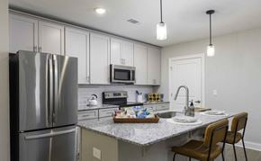 Titusville apartment for rent - Two-Bedroom Apartments In Titusville, FL - Riverwalk Grand - Kitchen With Stainless Steel GE Appliances, Granite Countertops, Wood Cabinetry with Soft Close, Kitchen Island, And LVP Flooring.