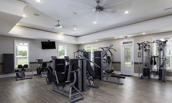 Fitness center featuring life fitness equipment including free weights & cardio machines