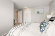 Bellevue apartment for rent - A bedroom with a large bed and a painting on the wall.