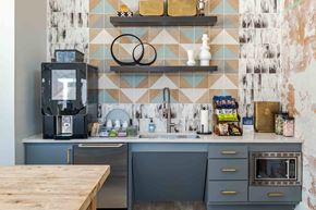 Centreville apartment for rent - A kitchen with a wooden table in front of a blue and white tiled wall.