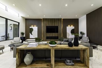 Goulds apartment for rent - A modern living room with a wooden coffee table and grey couches.