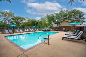 Benton apartment for rent - our resort style swimming pool is surrounded by lounge chairs and umbrellas