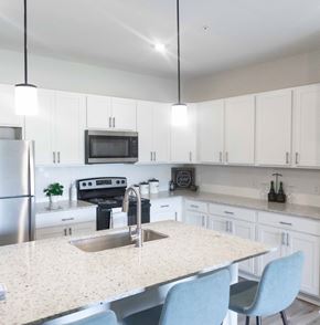 Hixson apartment for rent - a kitchen with white cabinets and a marble counter top