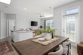 Holland apartment for rent - A modern dining room with a wooden table and chairs.