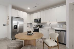 Santa Rosa Beach apartment for rent - A modern kitchen with a round table and a refrigerator.