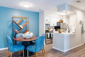 Ashburn apartment for rent - A dining room with a round table and blue chairs.
