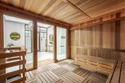 Tampa apartment for rent - A wooden sauna room with a bench and a door.