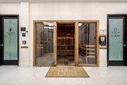Tampa apartment for rent - The entrance to a building with a glass door and a wooden door.