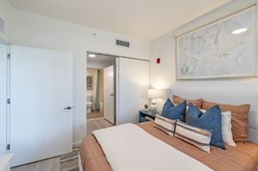 Goulds apartment for rent - A bedroom with a large bed and a painting on the wall.