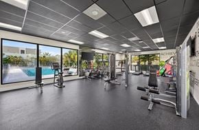 Goulds apartment for rent - A gym with a variety of equipment and a sign that says "ACHIEVE".
