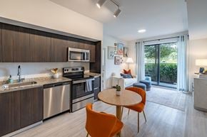 Goulds apartment for rent - A modern kitchen with a dining table and chairs.