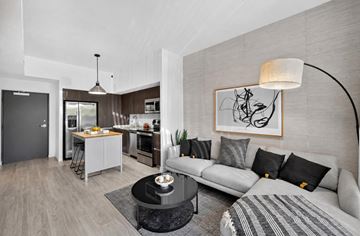 Goulds apartment for rent - A modern living room with a grey sofa and a coffee table.