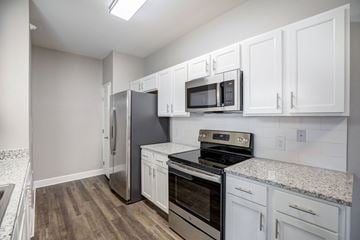Colorado Springs apartment for rent - a kitchen with white cabinets and stainless steel appliances