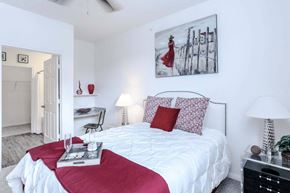 Ingleside apartment for rent - a bedroom with a white bed with red pillows