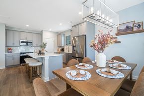 Gainesville apartment for rent - A modern kitchen with a dining table set for four.