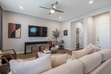 Gainesville apartment for rent - A living room with a white couch and a ceiling fan.